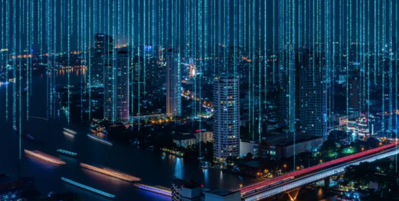 A photo of a city skyline with blue light orbs shooting up from the buildings into the night sky. 