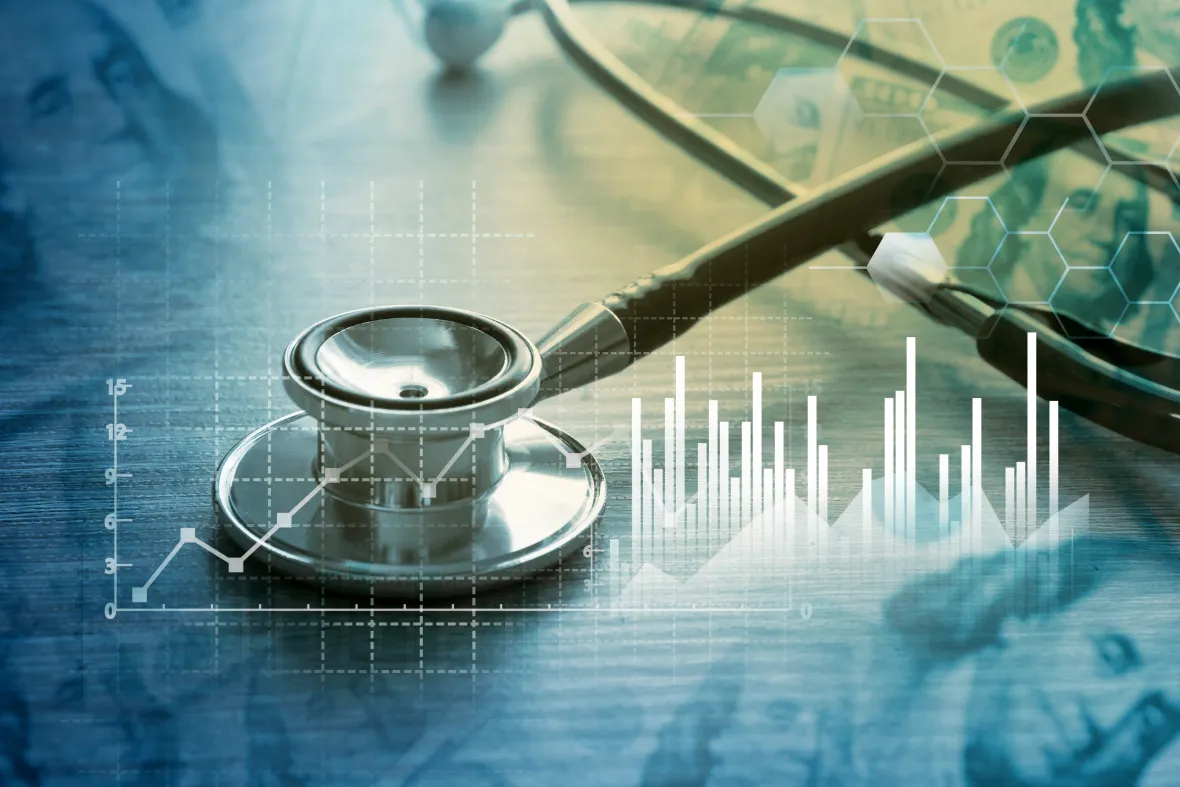 Stethoscope on a desk overlaid with charts and data visuals, representing healthcare data analytics and medical cost insights.